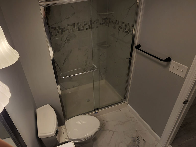 The Basic Bathroom Co. - full bathroom installation including a sink, faucet, toilet, shower pan and plumbing, and shower trim for a full bathroom build in a finished basement in Old Bridge, New Jersey – August 2022
