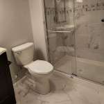The Basic Bathroom Co. - full bathroom installation including a sink, faucet, toilet, shower pan and plumbing, and shower trim for a full bathroom build in a finished basement in Old Bridge, New Jersey – August 2022