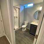 The Basic Bathroom Co. - full bathroom installation including a sink, faucet, toilet, shower pan and plumbing, and shower trim for a full bathroom build in a finished basement in Budd Lake, New Jersey – September 2022